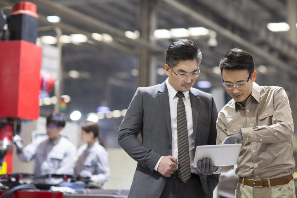 Quality expert talking with a client. TRIGO China offers quality solutions services for automotive professionals.
