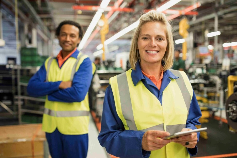 Quality Inspector holding a tablet in an automotive production line