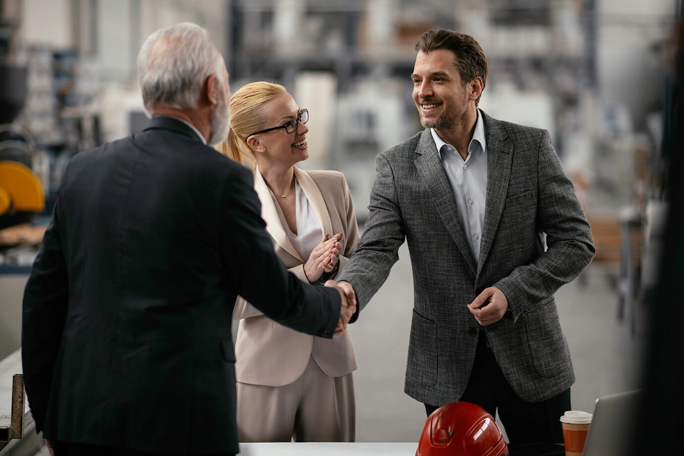 People shaking hands in factory