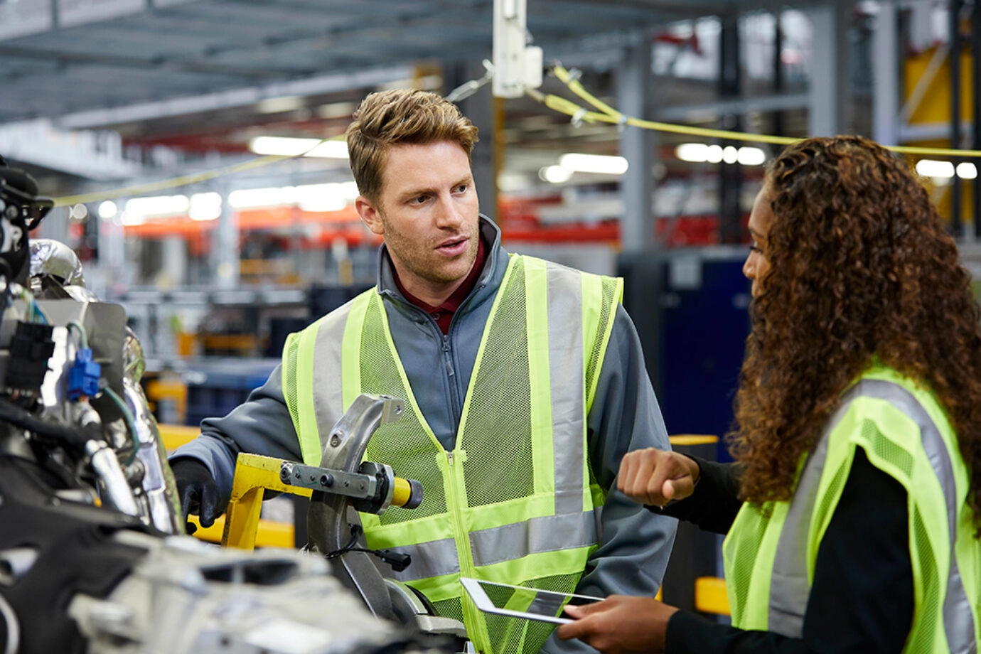 Man and woman talking in a factory